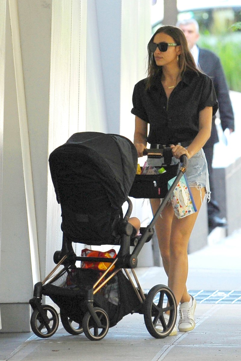 Irina Shayk in a Black Top and Jean Shorts With a Black Stroller