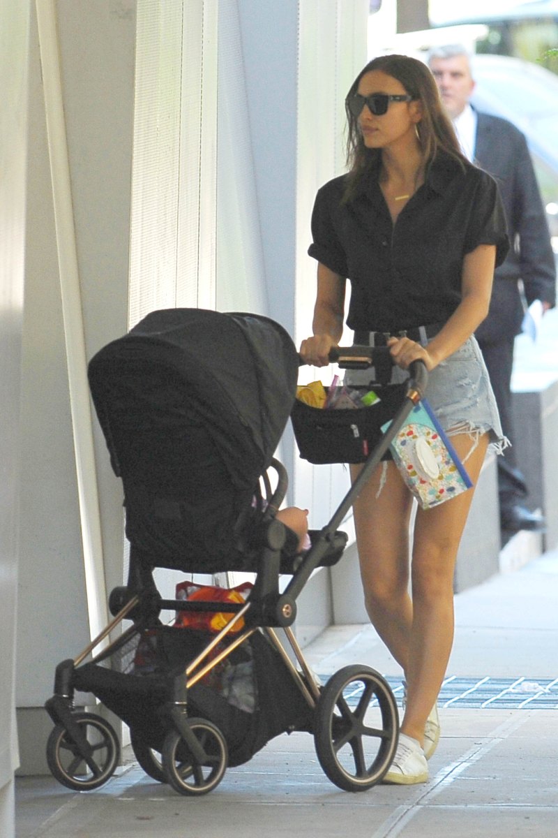 Irina Shayk in a Black Top and Jean Shorts With a Black Stroller