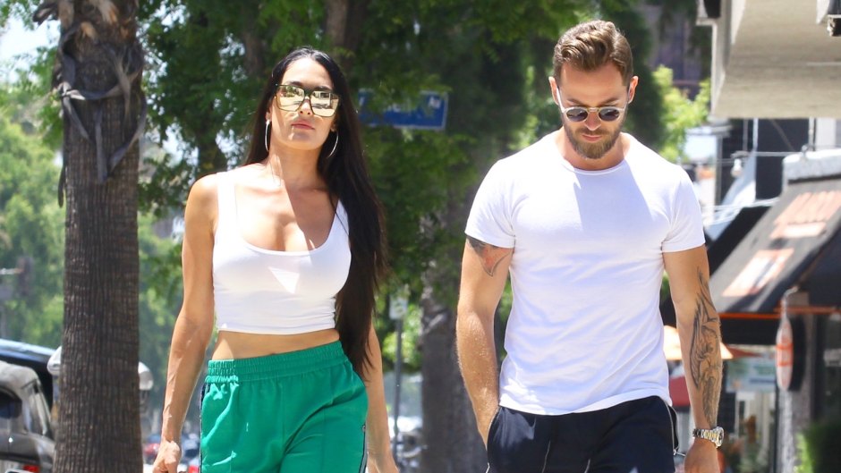 Nikki Bella in Green Track Pants and White Crop Top Running Errands With Artem Chigvintsev in Jeans and White Tshirt
