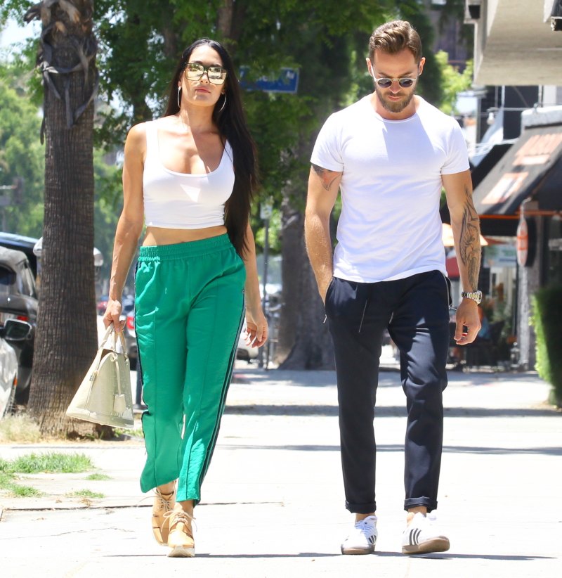 Nikki Bella in Green Track Pants and White Crop Top Running Errands With Artem Chigvintsev in Jeans and White Tshirt