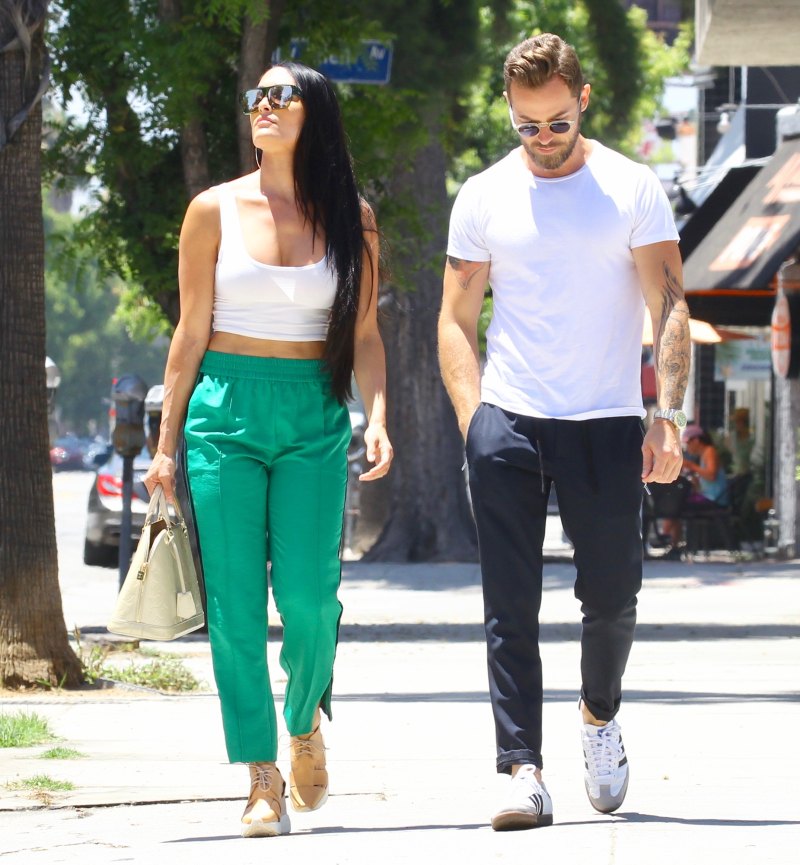Nikki Bella in Green Track Pants and White Crop Top Running Errands With Artem Chigvintsev in Jeans and White Tshirt