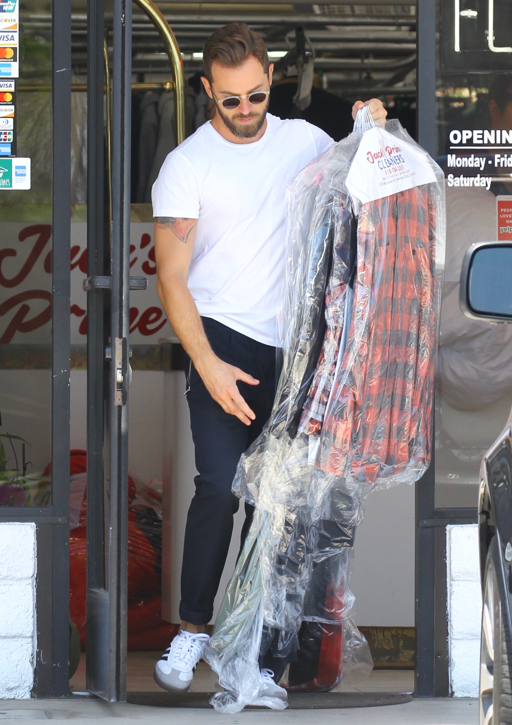 Nikki Bella in Green Track Pants and White Crop Top Running Errands With Artem Chigvintsev in Jeans and White Tshirt