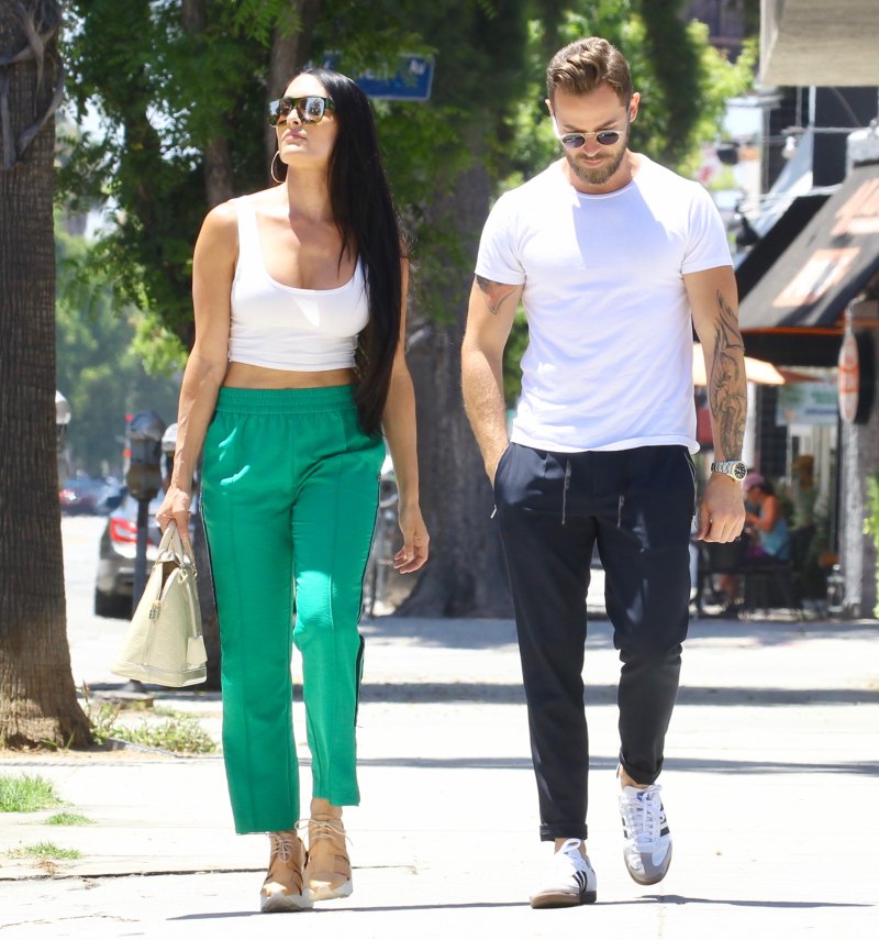 Nikki Bella in Green Track Pants and White Crop Top Running Errands With Artem Chigvintsev in Jeans and White Tshirt