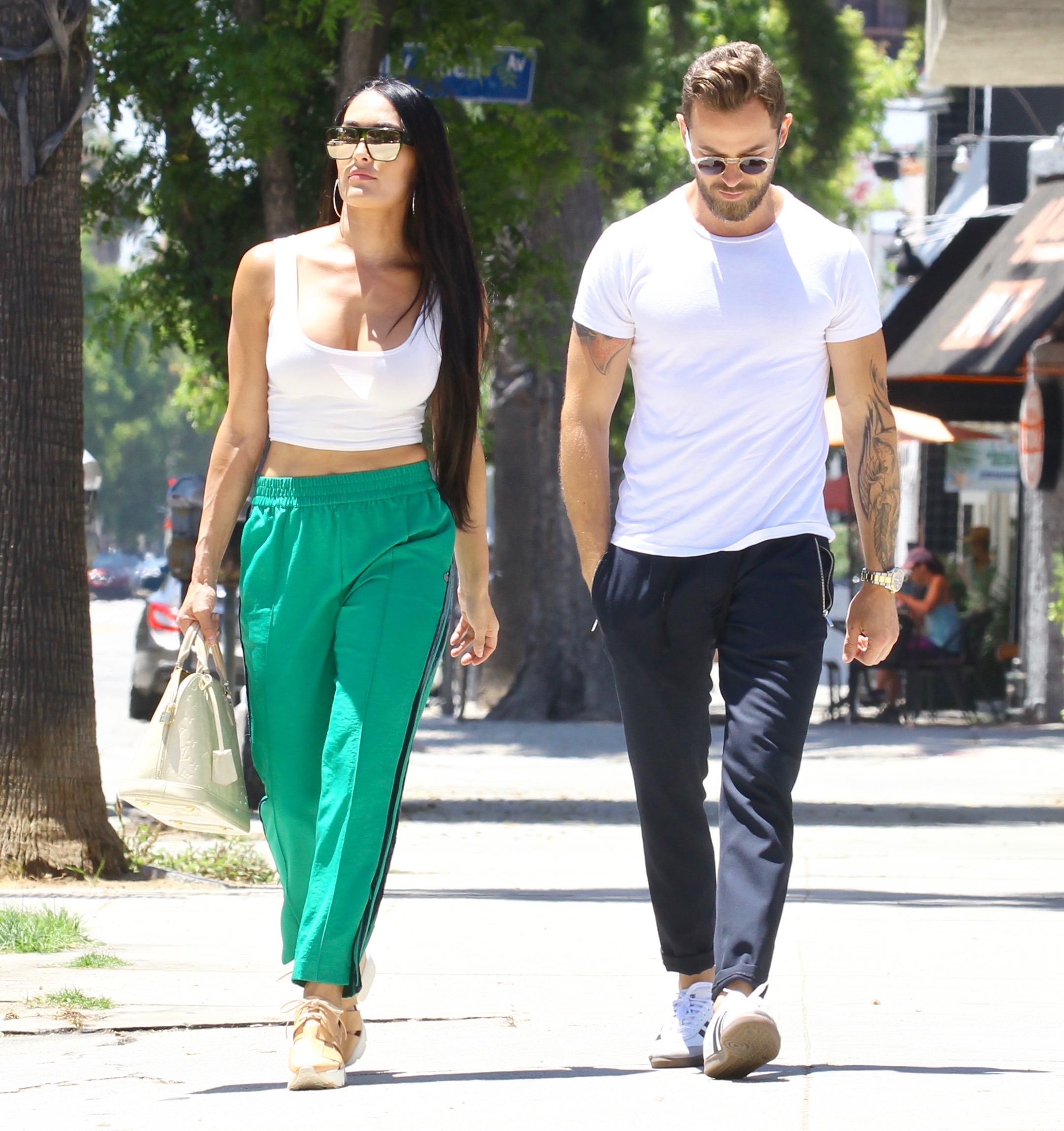 Nikki Bella in Green Track Pants and White Crop Top Running Errands With Artem Chigvintsev in Jeans and White Tshirt