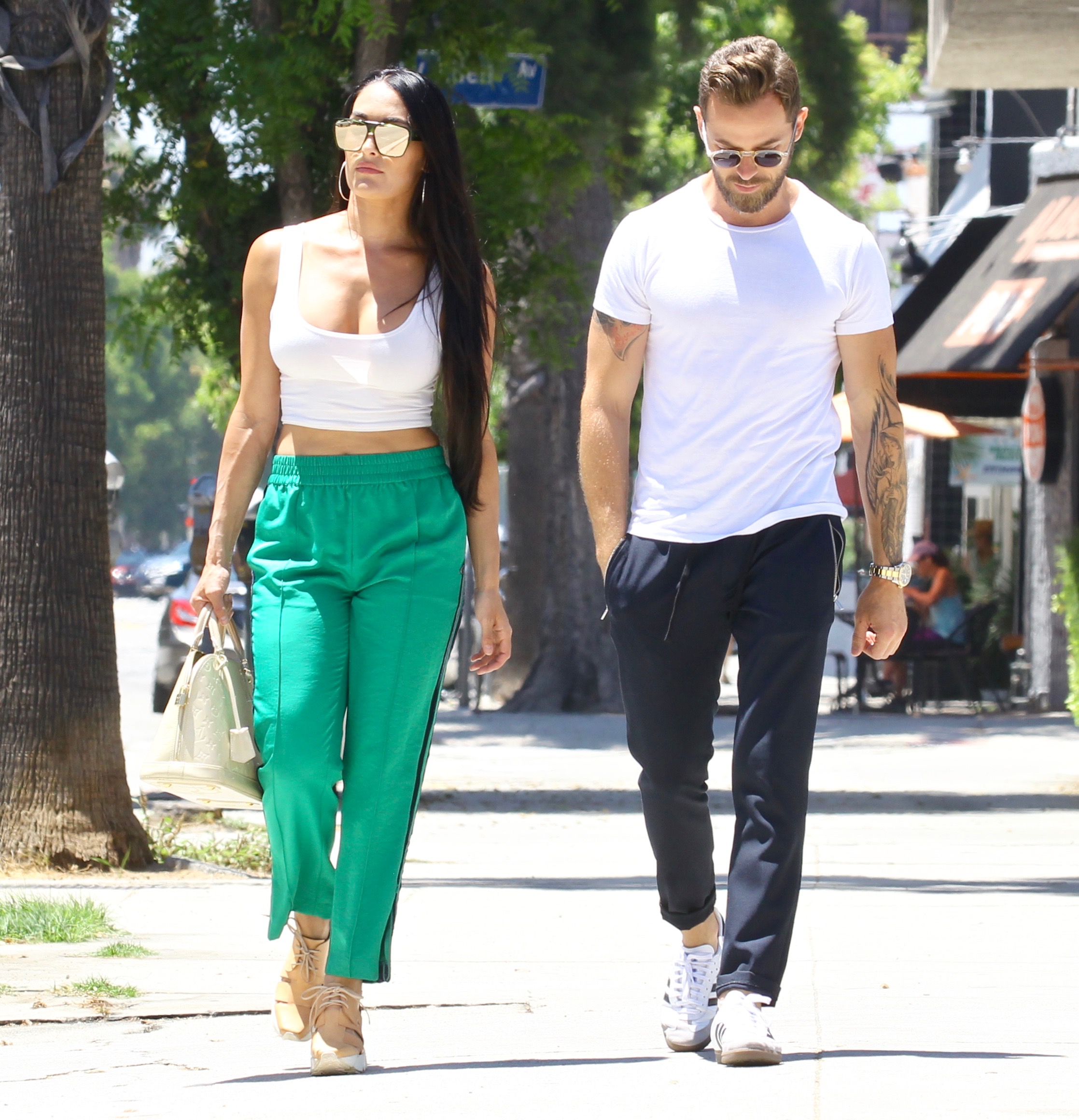 Nikki Bella in Green Track Pants and White Crop Top Running Errands With Artem Chigvintsev in Jeans and White Tshirt