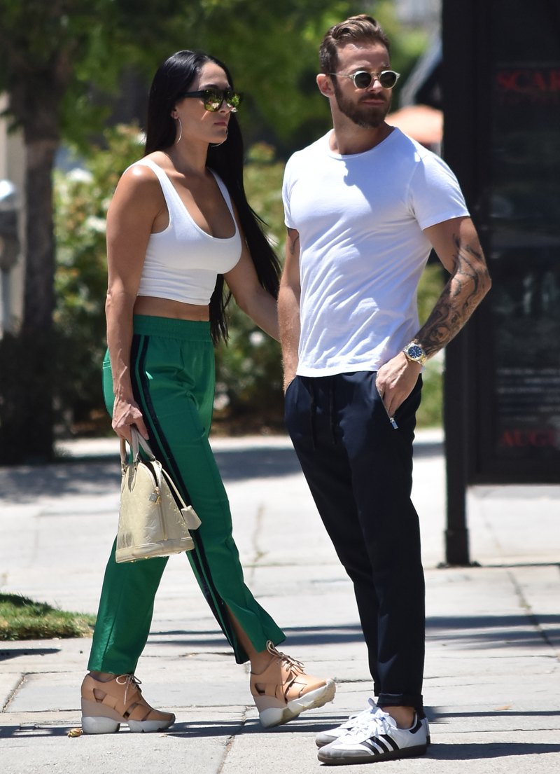 Nikki Bella in Green Track Pants and White Crop Top Running Errands With Artem Chigvintsev in Jeans and White Tshirt