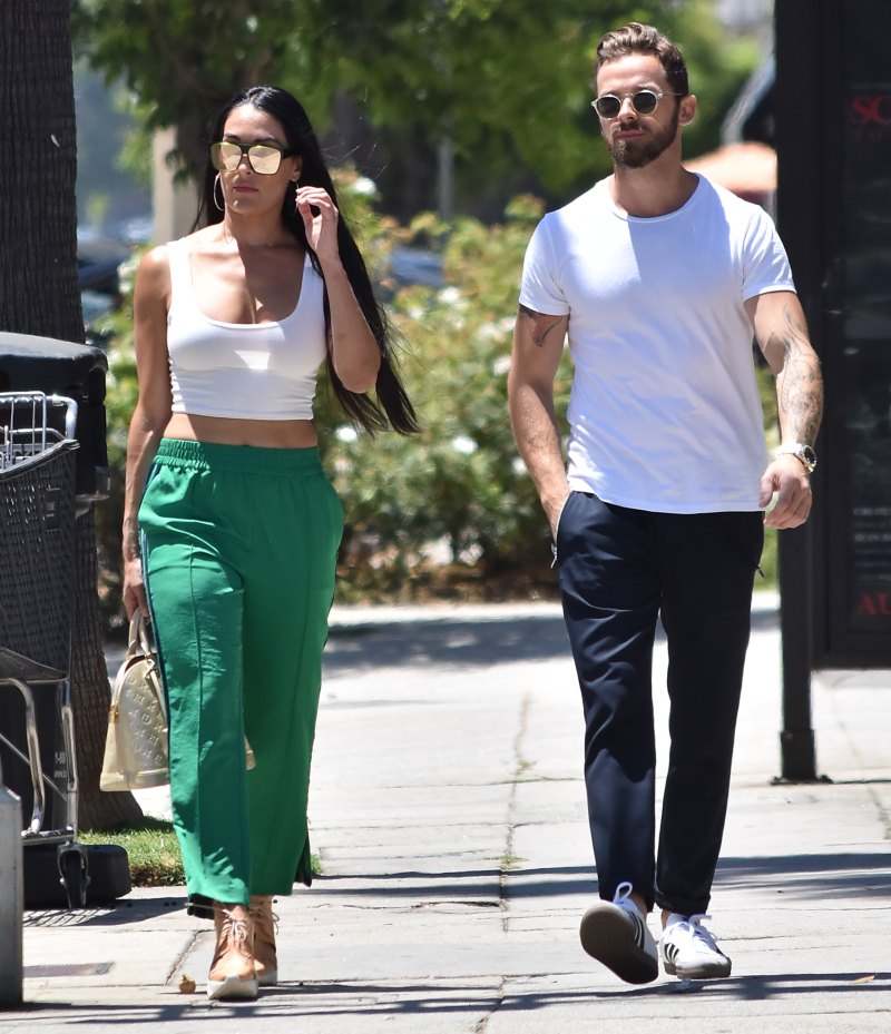 Nikki Bella in Green Track Pants and White Crop Top Running Errands With Artem Chigvintsev in Jeans and White Tshirt