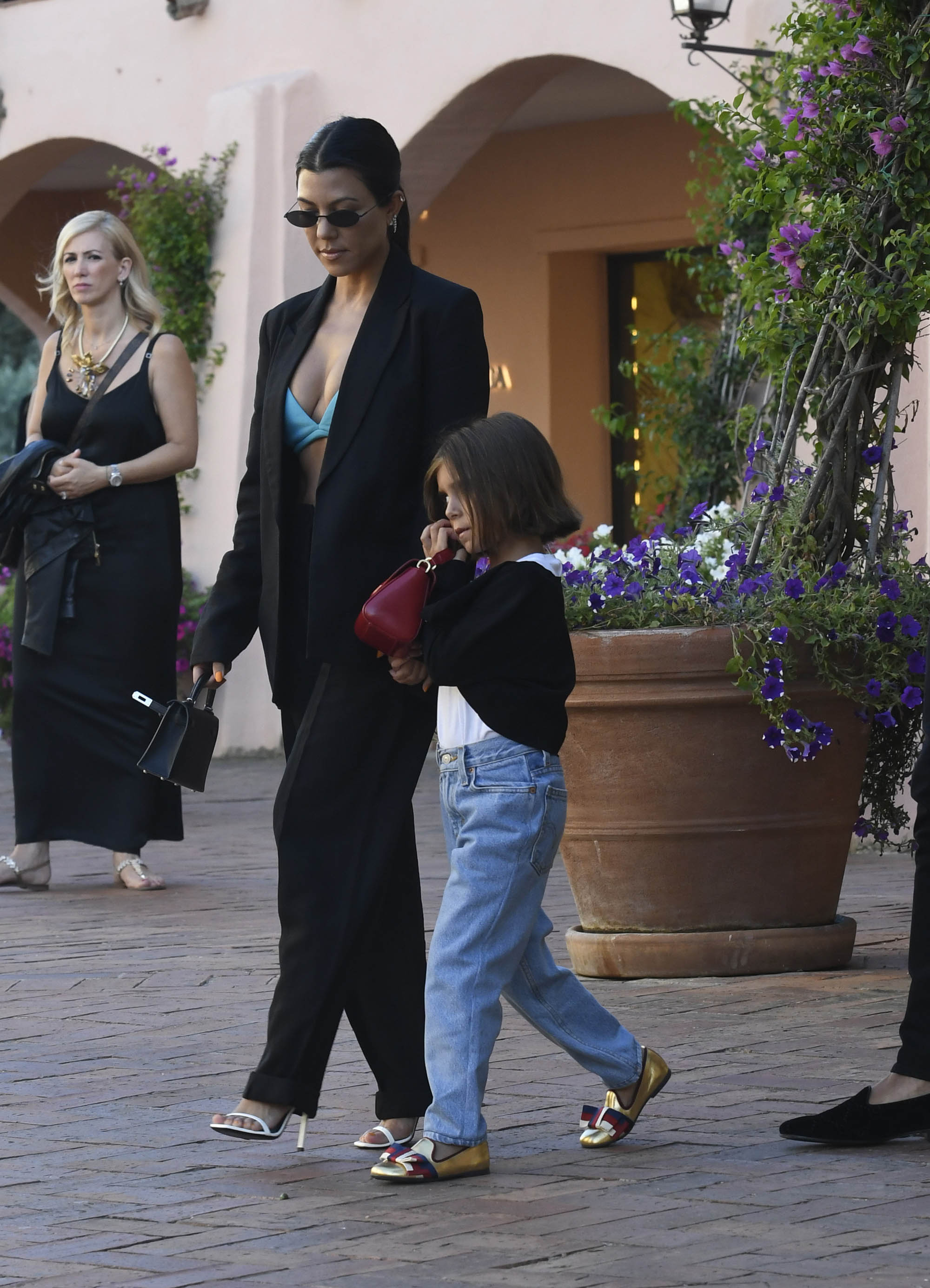 Kourtney Kardashian Out With Penelope Disick in Italy Wearing Green Bra and Black Suit