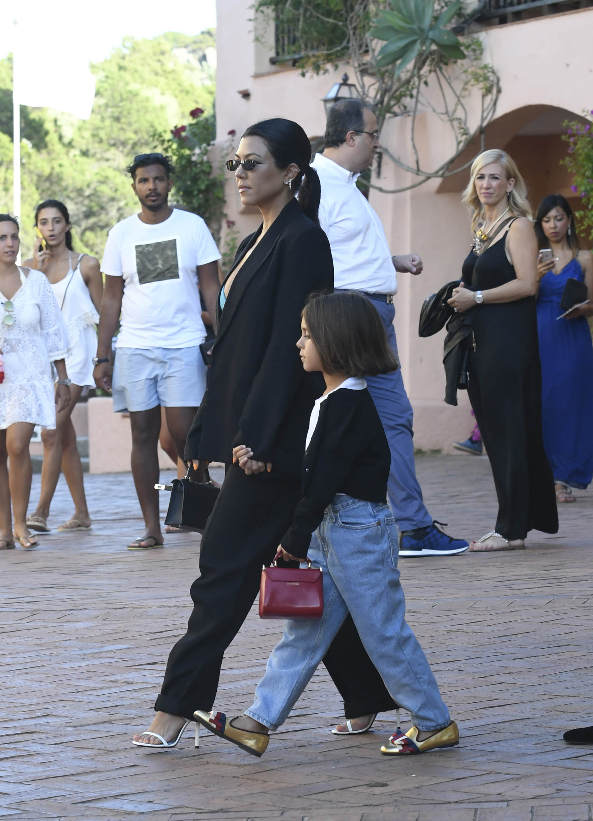 Kourtney Kardashian Out With Penelope Disick in Italy Wearing Green Bra and Black Suit