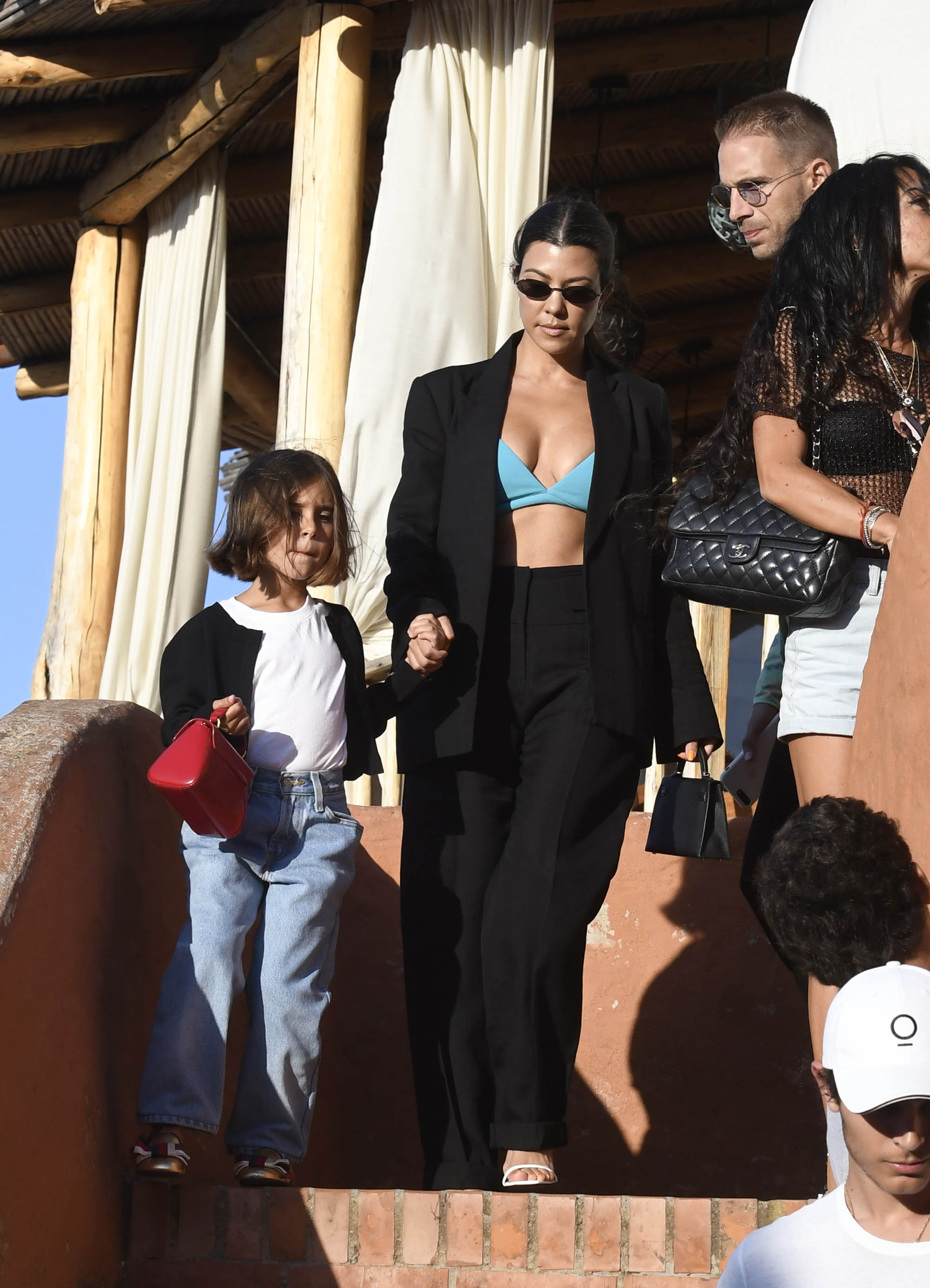 Kourtney Kardashian Out With Penelope Disick in Italy Wearing Green Bra and Black Suit