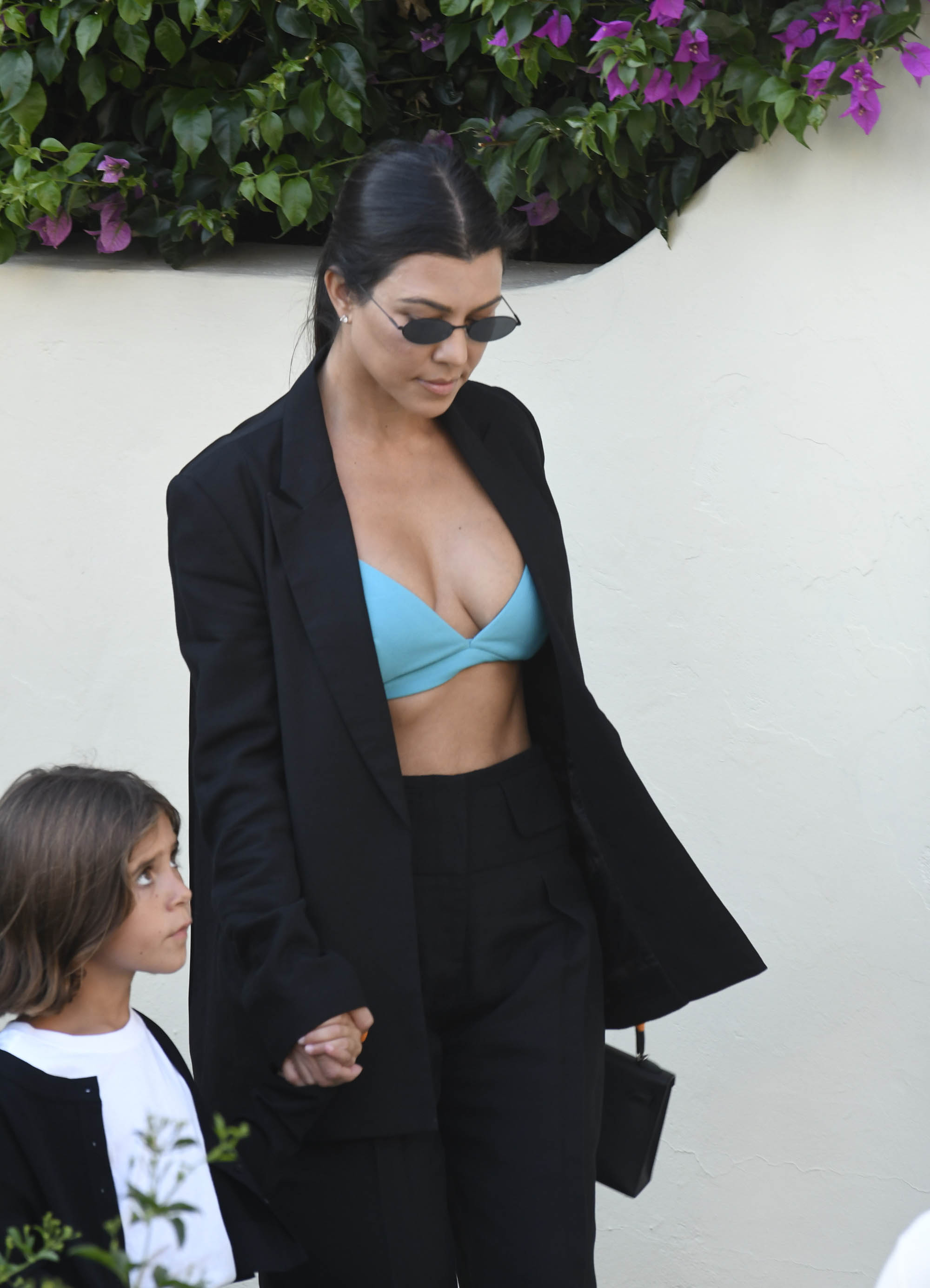 Kourtney Kardashian Out With Penelope Disick in Italy Wearing Green Bra and Black Suit