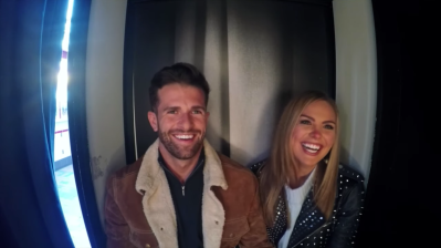 Jed Wyatt Wearing a Brown Coat with Hannah Brown in a Photobooth