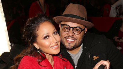 Adrienne Bailon Wearing a Red Outfit With Israel Houghton
