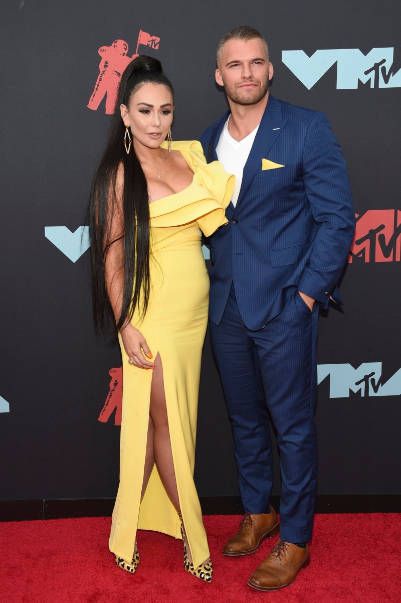 JWoww wearing a yellow dress and posing with her boyfriend