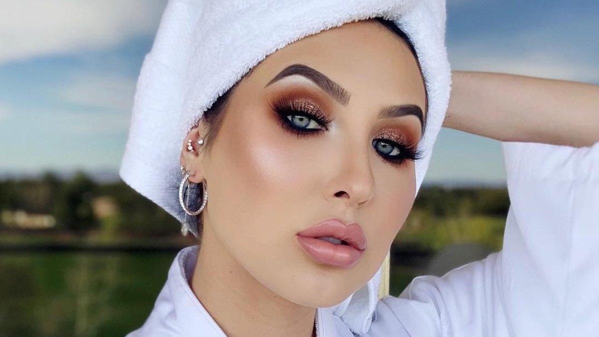 Jaclyn Hill taking a selfie wearing a bathrobe and towel on her head