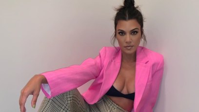 Kourtney Kardashian in a hot pink blazer and black bra