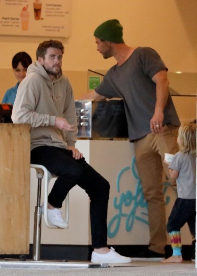 Liam Hemsworth Sitting on A Stool at a Cafe in Australia