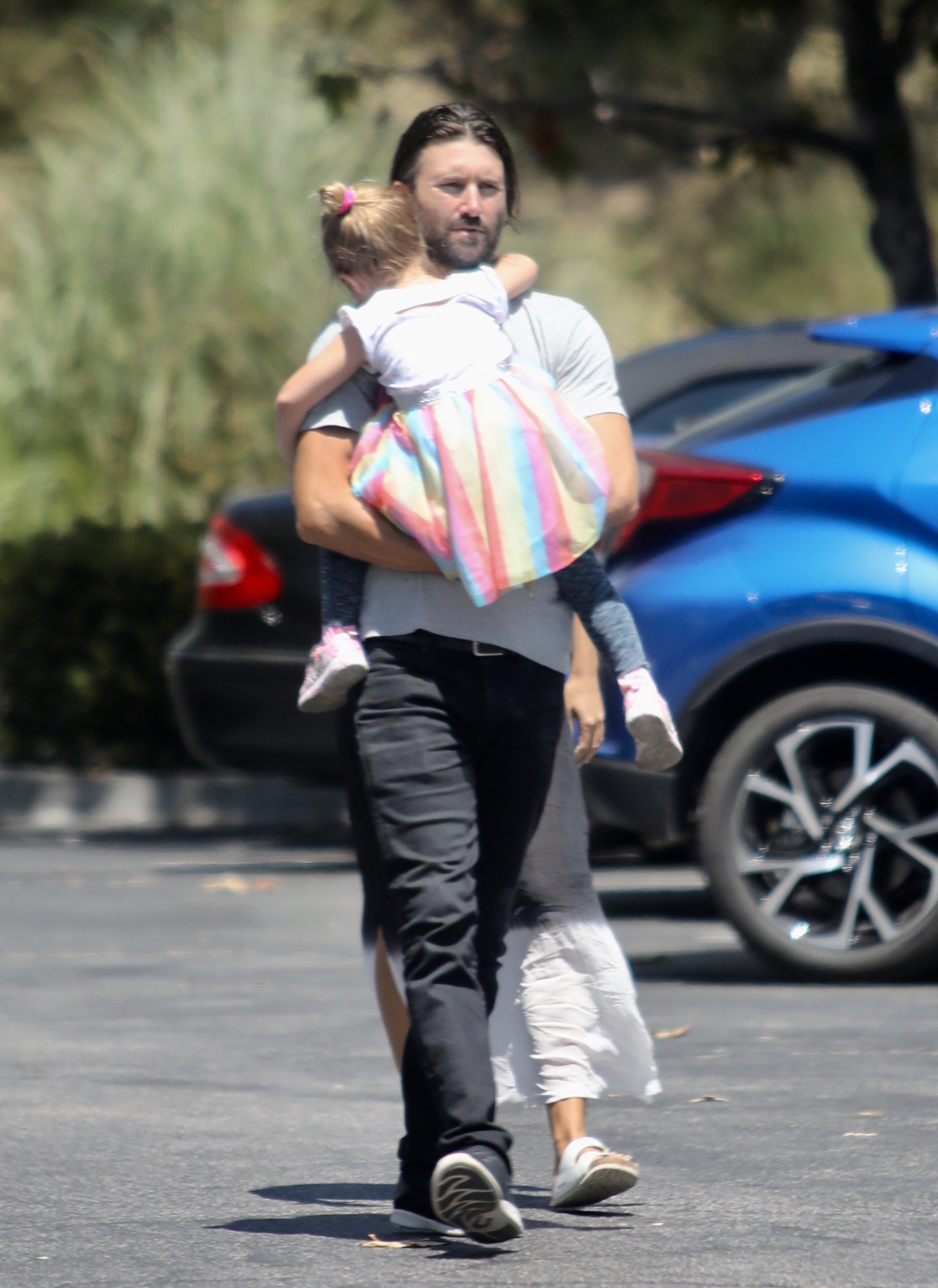 Brandon Jenner out running errands blue shirt and jeans holding daughter Eva while running errands