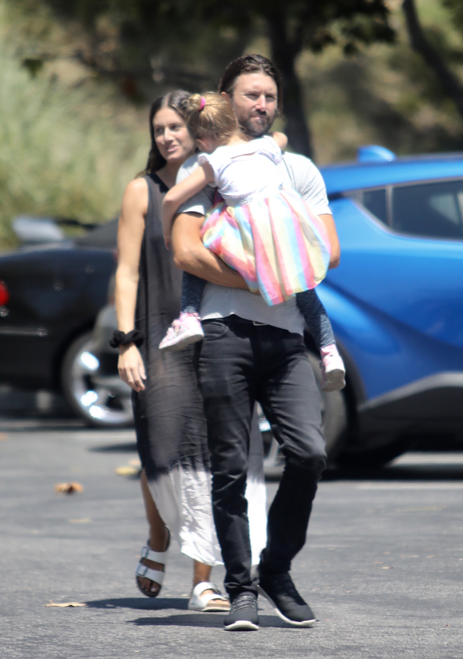 Brandon Jenner out running errands blue shirt and jeans holding daughter Eva and pregnant Cayley Stoker in sheer dress