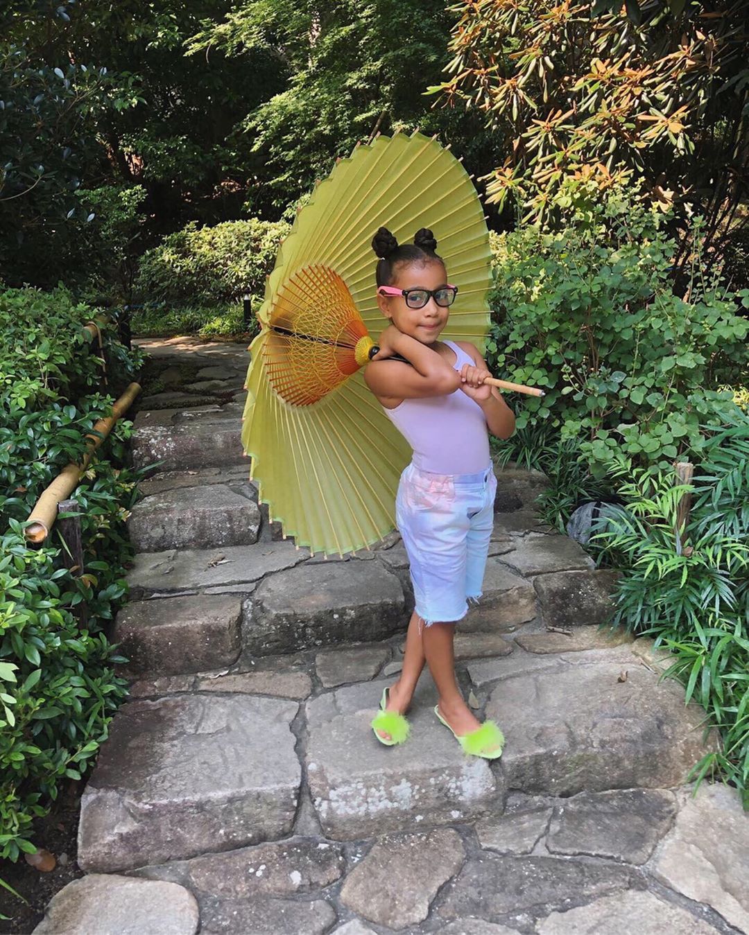 North West in Japan With Yellow Parasail and Black Rimmed Glasses