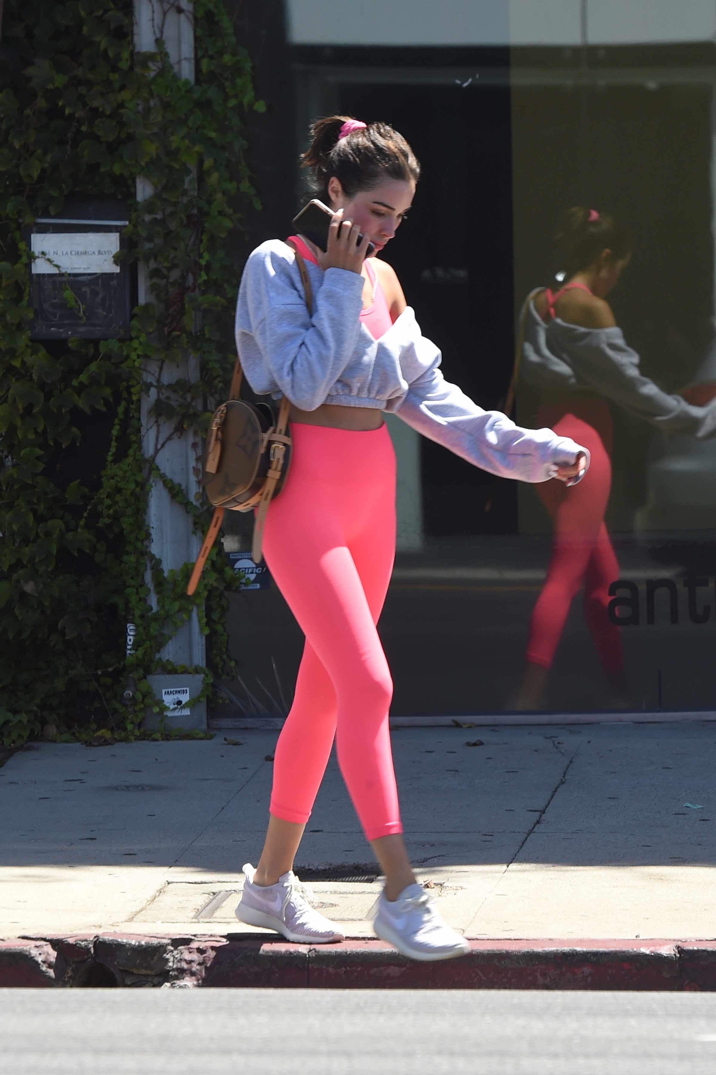 Olivia Culpo in a Crop Top and Hot Pink Leggings