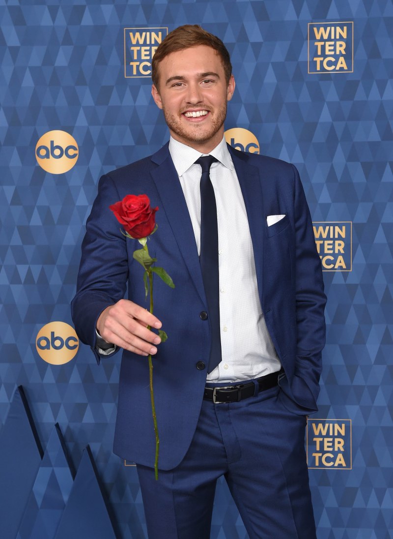 Bachelor Peter Weber Holds a Red Rose While Wearing a Blue Suit