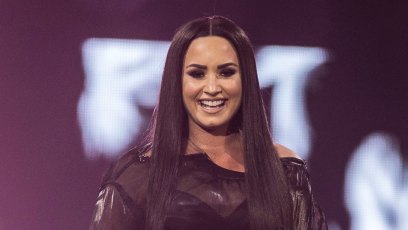 Demi Lovato Long Black Straight Hair and Black Costume on Stage Birthday Message