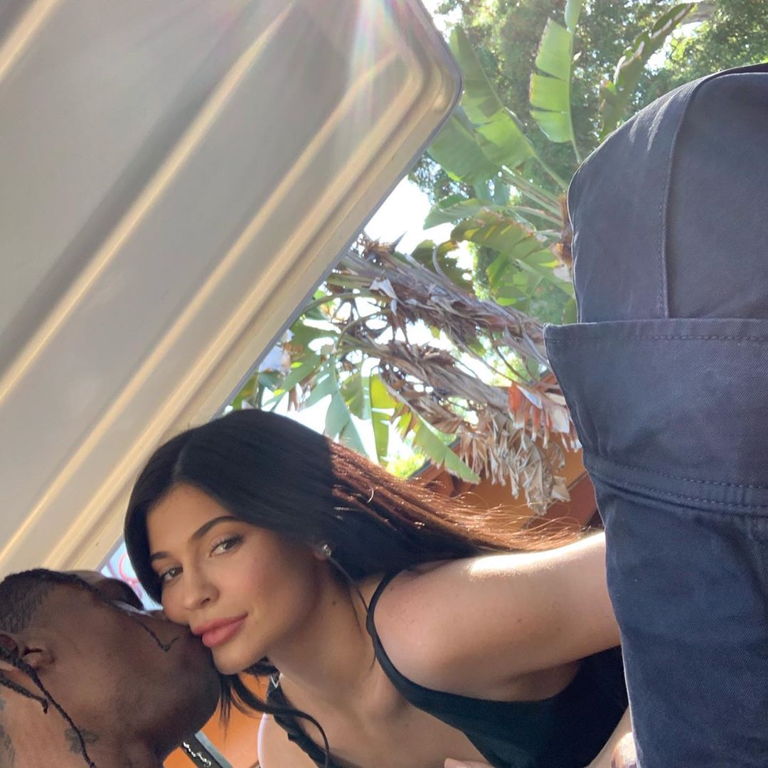 TravisScott is surrounded by @louisvuitton luggage & #lv bag, and