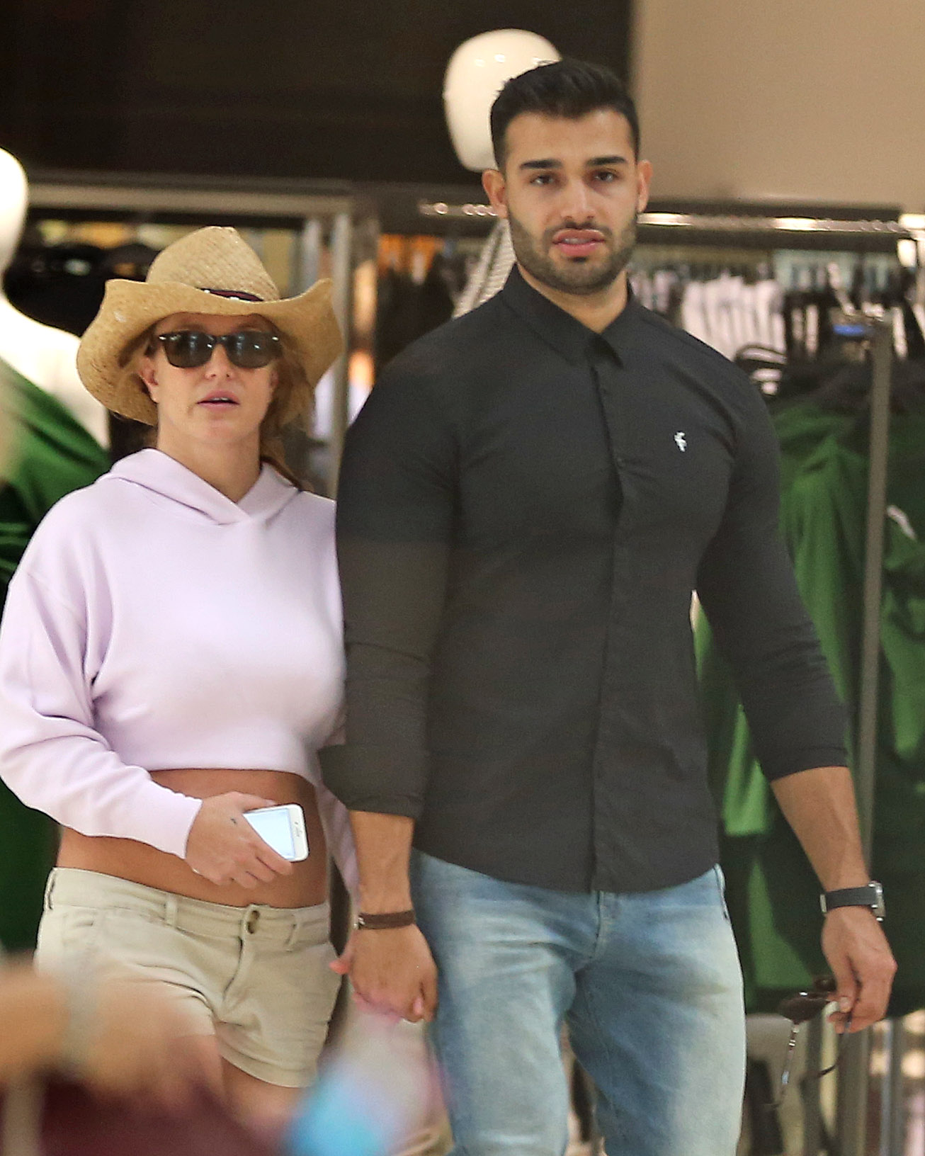 Britney Spears and boyfriend Sam Asghari hold hands while walking in the mall