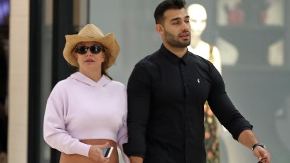 Britney Spears and boyfriend Sam Asghari hold hands while walking in the mall