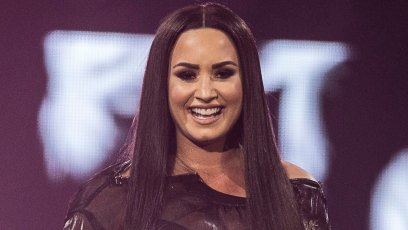 Demi Lovato Smiling On Stage in Sheer Black Top and Body Suit