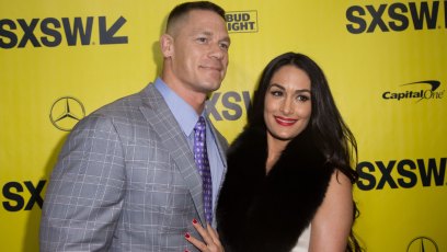 John Cena and Nikki Bella smiling on the red carpet