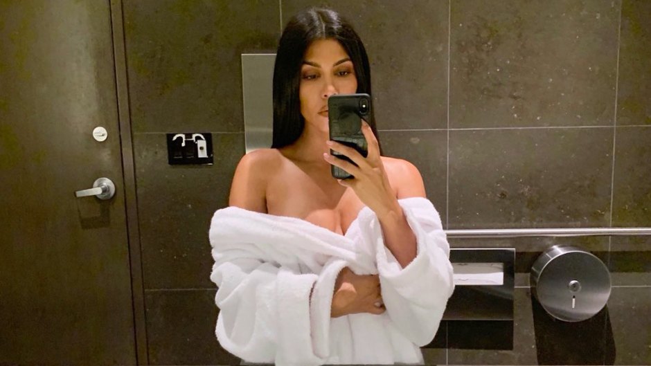 Kourtney Kardashian taking a selfie in a bathrobe
