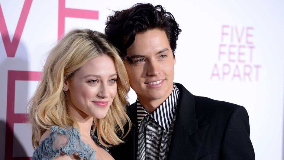 Lili Reinhart and Cole Sprouse posing with their heads close together and smiling