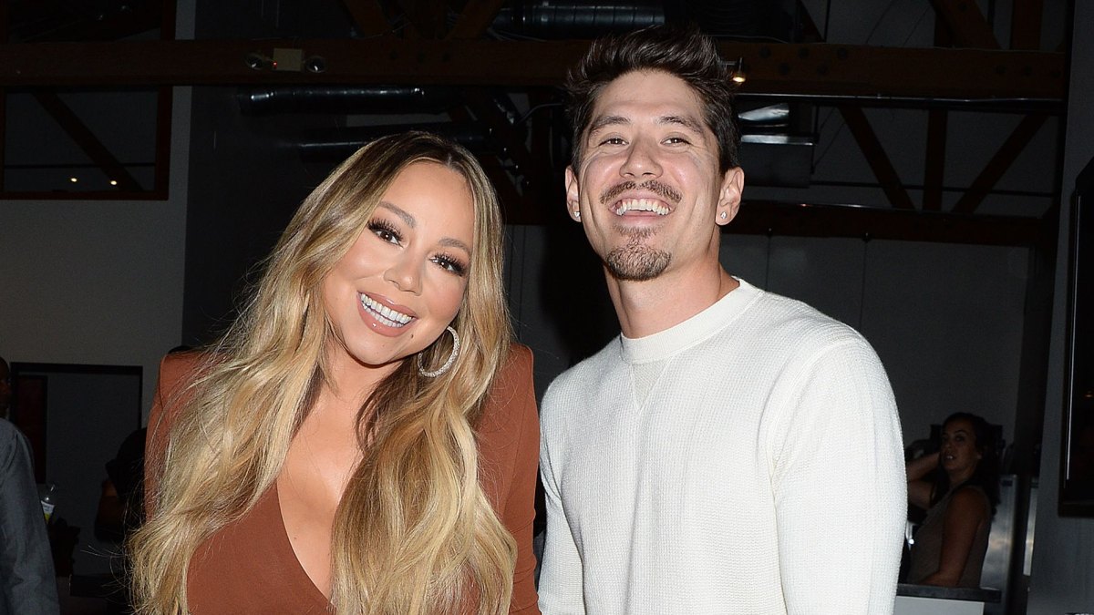 Mariah Carey and Bryan Tanaka smiling and holding hands