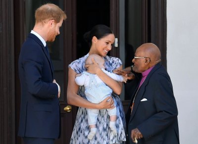 Prince Harry and Meghan Duchess of Sussex, holding their son Archie Harrison Mountbatten-Windsor, meet Archbishop Desmond Tutu
