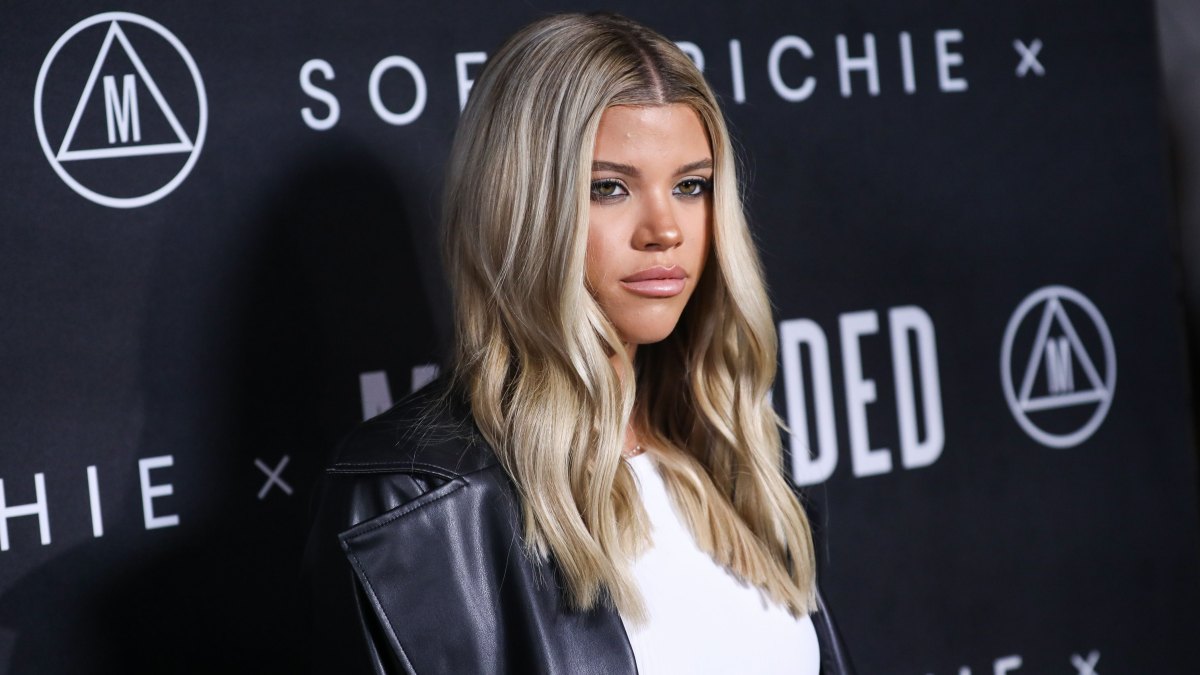 Sofia Richie in a leather pantsuit and white crop top at her Missguided launch event