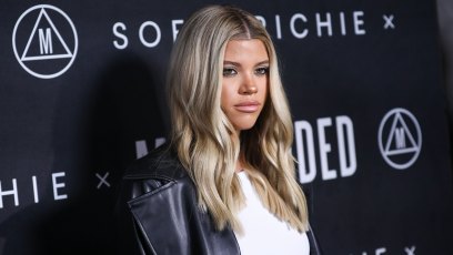 Sofia Richie in a leather pantsuit and white crop top at her Missguided launch event