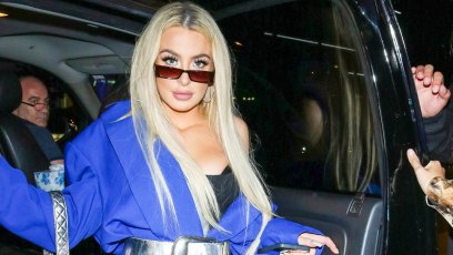 Tana Mongeau in biker shorts, thigh-high boots and oversized jacket