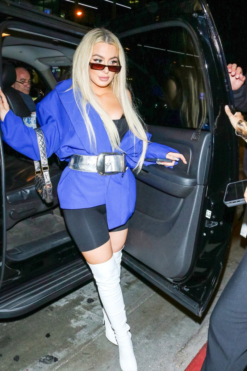 Tana Mongeau in biker shorts, thigh-high boots and oversized jacket