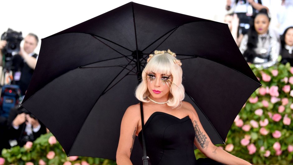 Lady Gaga in a black dress carrying an umbrella at the 2019 Met Gala