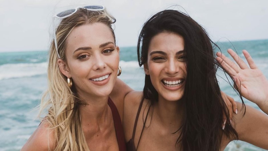 Two women smiling in bikinis on the beach