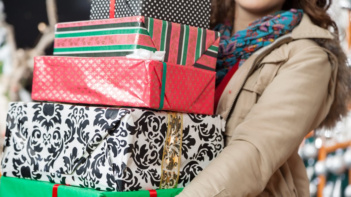 A Woman Holding Wrapped Holiday Presents