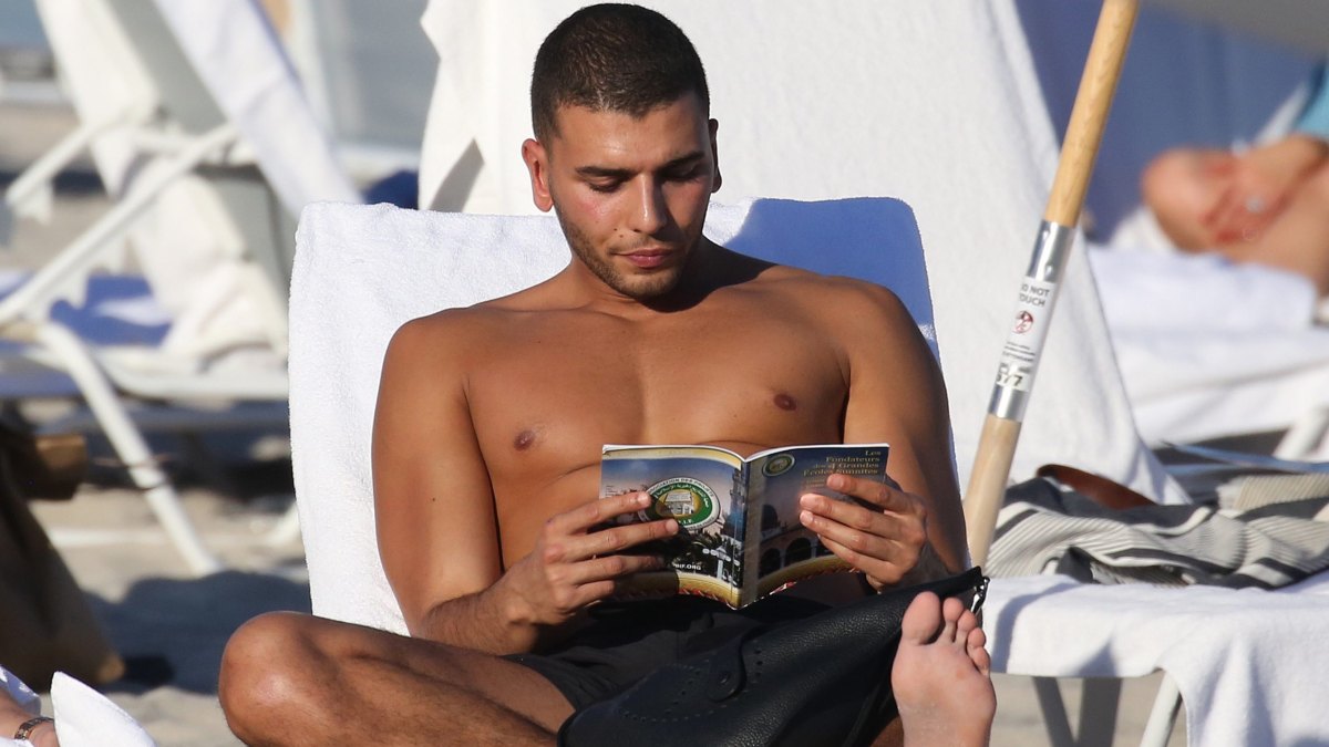 Younes Bendjima Reads Shirtless on the Beach