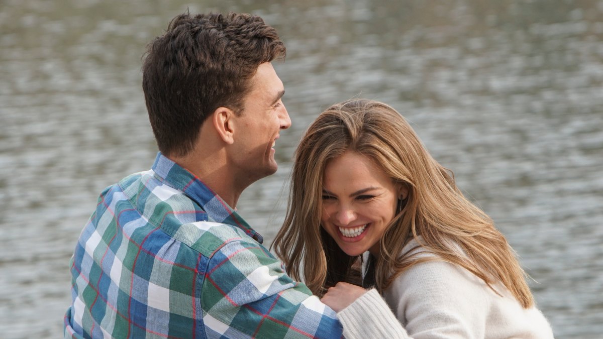 Bachelorette Tyler Cameron Wears a Plaid Shirt and Sits on a Bench With Hannah Brown Laughing