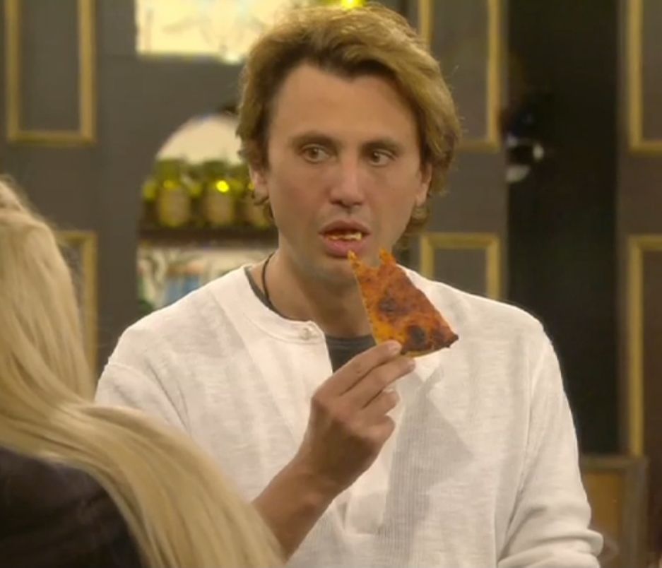 Jonathan Cheban Eating a Pizza in a white Shirt