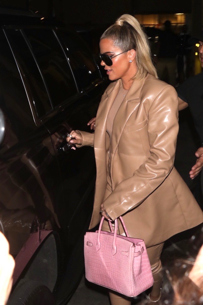 Khloe Kardashian Wears Brown Leather Suit With Pink Purse and Sunglasses