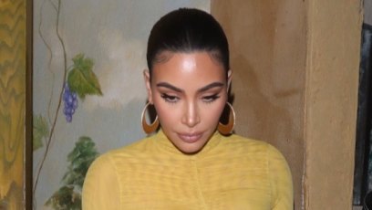 Kim Kardashian Wears Tight yellow Dress With Ponytail and Brown Hoop Earrings
