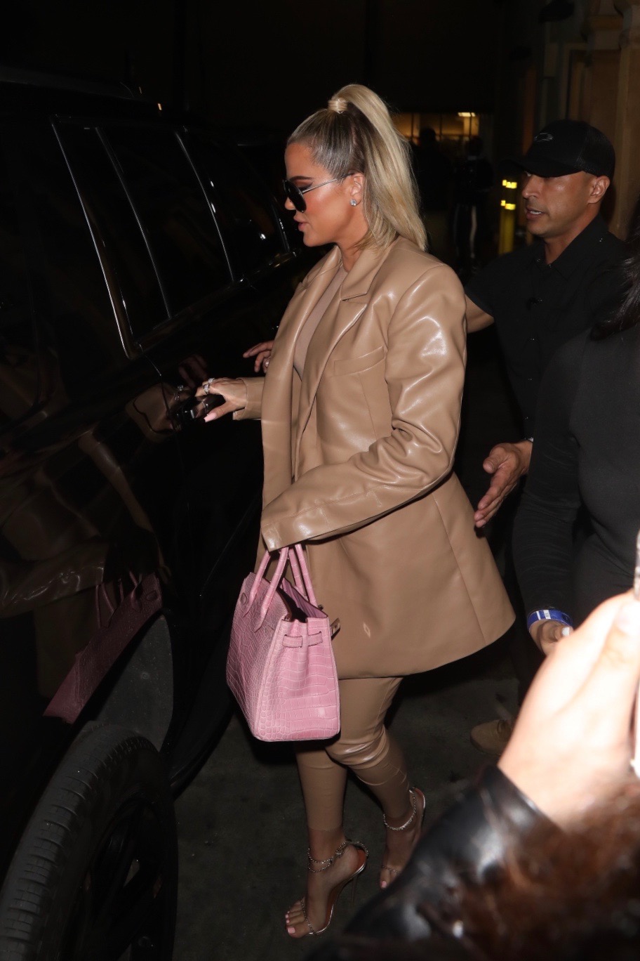 Khloe Kardashian Wears Brown Leather Suit With Pink Purse and Sunglasses Leaving Dinner