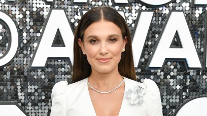 Millie Bobby Brown Smiles in White Suit Dress
